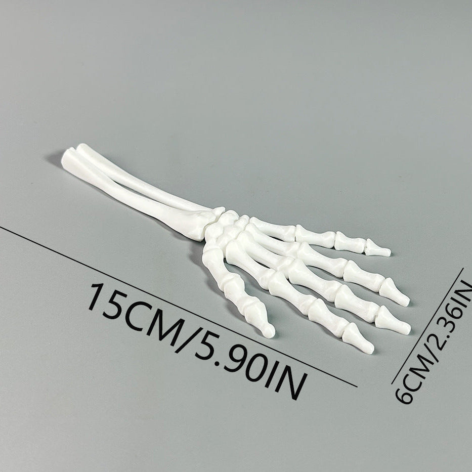 Model of a human hand骨骼 on a gray background with measurements indicated.