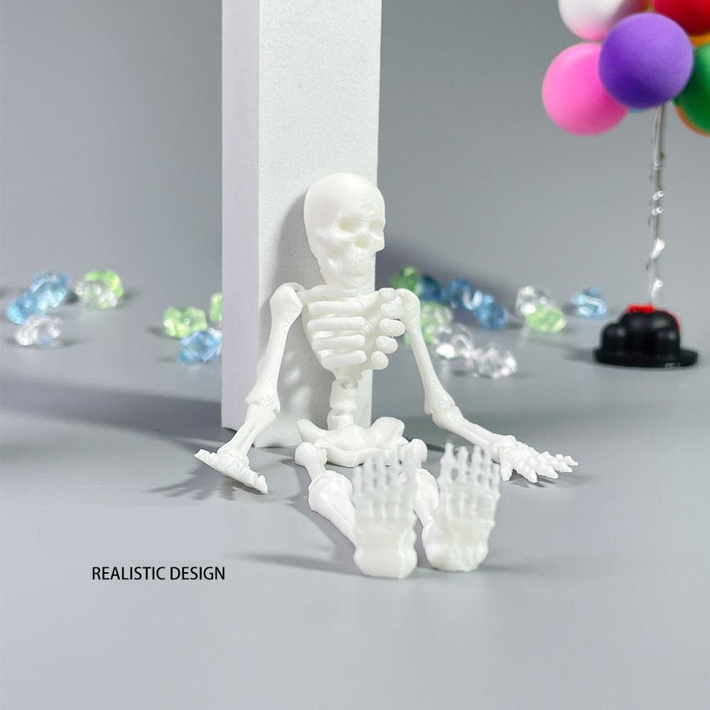 White skeleton model on a gray surface with colorful balloons and decorations in the background.