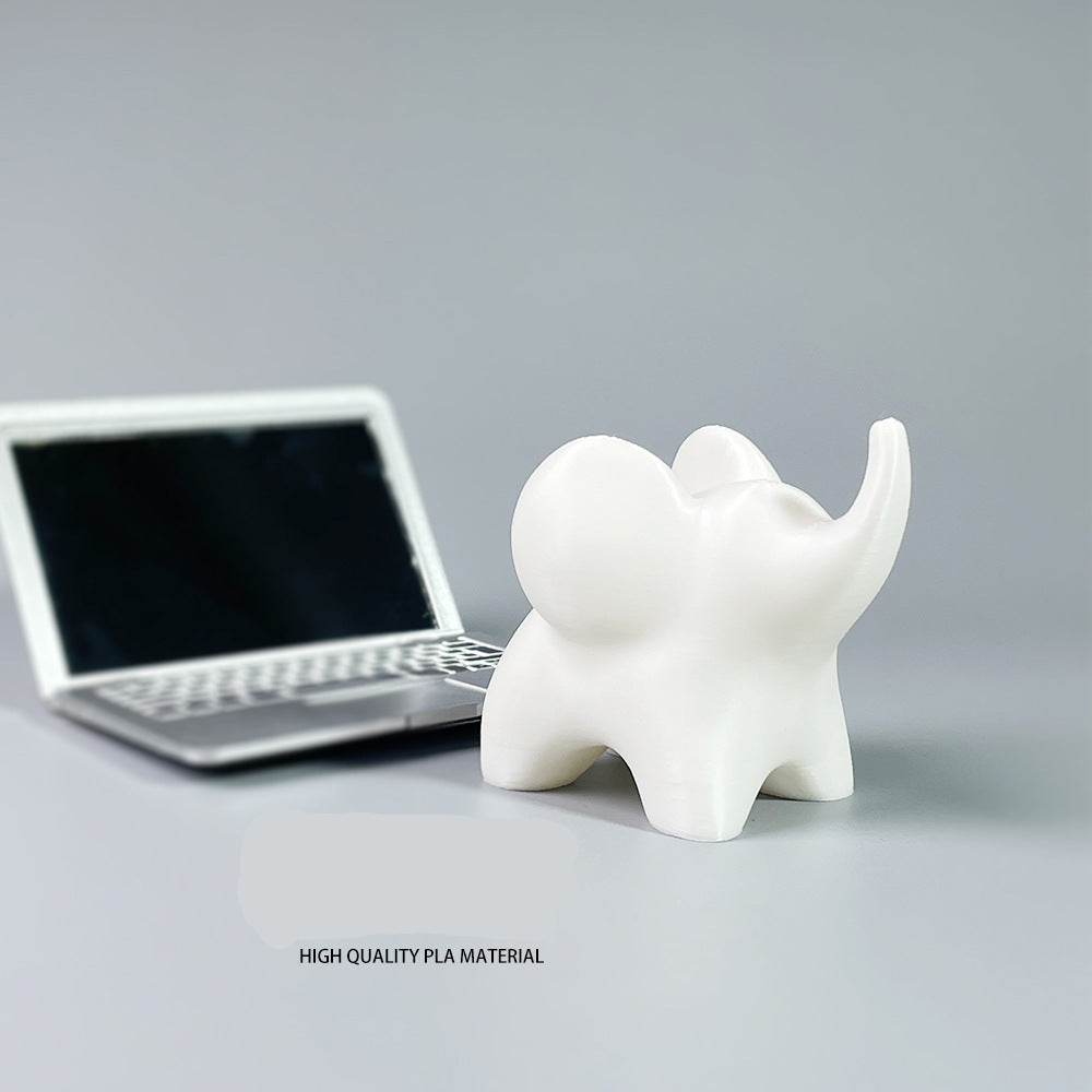 White elephant-shaped object next to a laptop on a gray surface with text about high-quality PLA material.