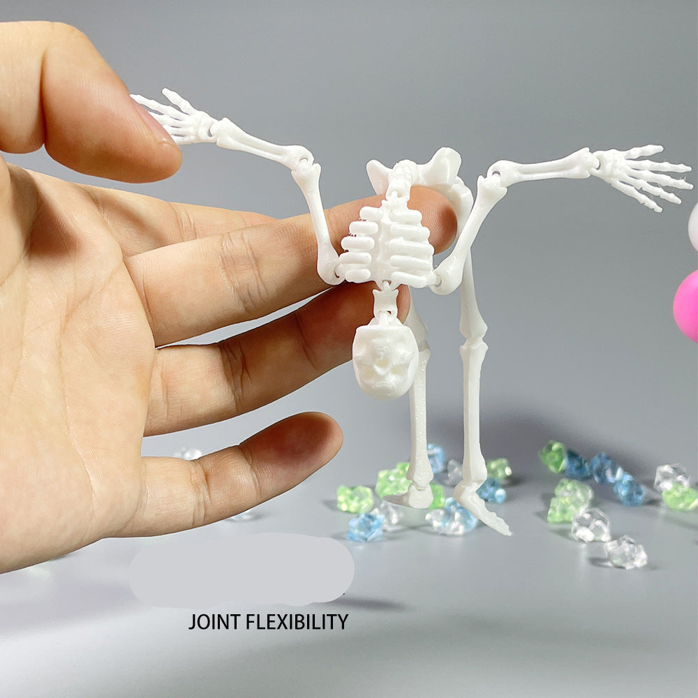 Hand holding a small plastic skeleton model with text 'Joint Flexibility' on a gray background